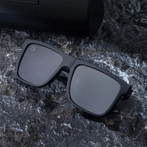 Polarized square frame sunglasses for men on rock background with leather case