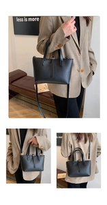 Detail of black lychee grain leather tote bag with top handles and adjustable shoulder strap