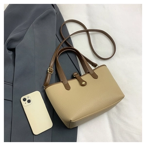 Top-down view of khaki lychee leather bucket bag with brown straps and buckle details