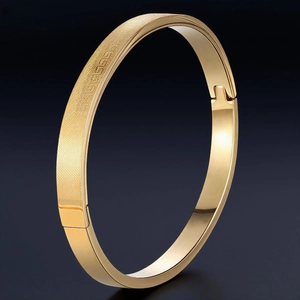 Polished gold stainless steel bangle with textured diagonal patterns and a secure clasp