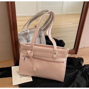 Mirror reflection showing front and back details of a pink PU leather tote bag with ribbon bow