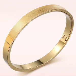 Minimalist gold titanium steel hinged bracelet with matte brushed and engraved textures