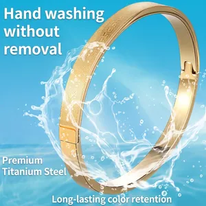 Gold titanium steel bracelet with textured finish and side clasp on blue water background