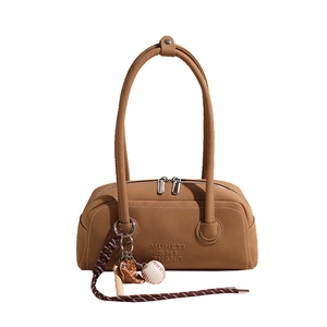 Brown leather bowling bag with vintage texture and sports charms on white background