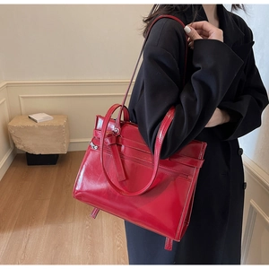 Red patent leather tote bag with handles and adjustable strap for commuting