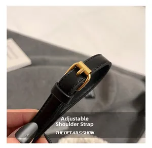 Detail of adjustable black leather strap with premium gold metal buckle for bucket bags