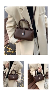Detailed close-up of dark brown leather crossbody bag with silver buckle and grainy texture