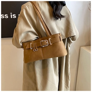 Close-up of tan leather bag featuring stylish silver buckles and fine lychee grain texture