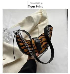 Detail of tiger print dumpling bag with chunky gold chain and leather shoulder strap