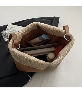 Interior view of large lamb wool bucket bag showing spacious storage for books and tablet