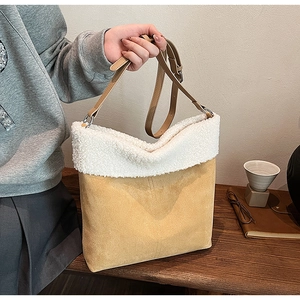Detail of tan suede and white faux fur patchwork on a stylish women's shoulder bag