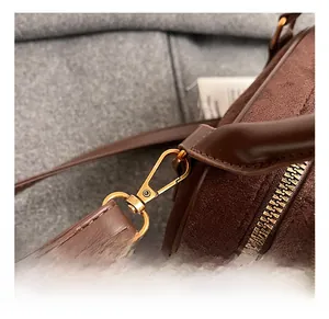 Detail of high-quality gold metal hook and premium brown suede leather on the bowling bag