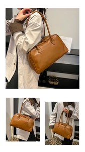 Detail of retro caramel brown tote bag with smooth texture and long shoulder straps