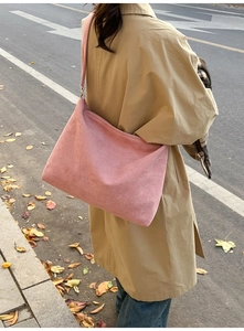 Pink matte suede shoulder bag shown in detail with soft texture and large capacity