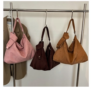 Detailed trio of matte hobo shoulder bags in pink, brown and caramel colors