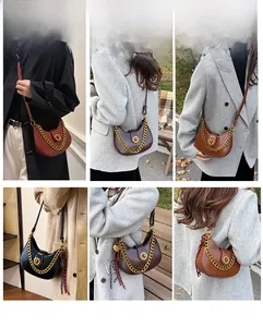 Detail of trendy crescent saddle bag with metallic chain and buckle in four rich colors