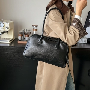 Retro black leather tote bag with oil wax texture shown in a casual lifestyle setting