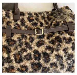 Detailed close-up of leopard print faux fur texture and leather strap with gold buckle