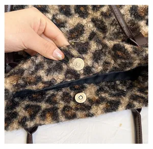 Detail of magnetic snap closure and leopard print faux fur texture on tote bag