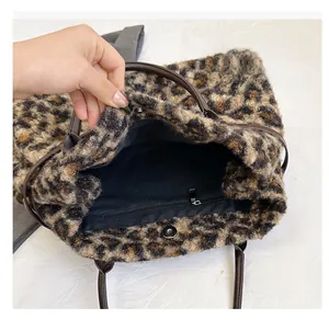 Detail view of leopard print tote bag interior with magnetic clasp and inner zip pocket
