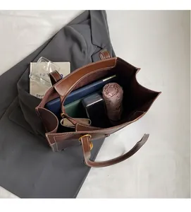 Spacious interior of brown leather tote bag showing large capacity for daily essentials