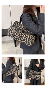 Close-up of plush leopard print tote bag with black leather straps and buckle detail