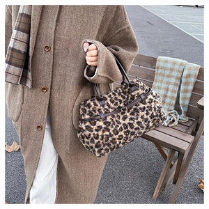 Outdoor shot of the leopard print tote bag with brown leather handles and buckle detail