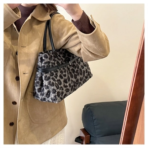 Leopard print plush tote bag shown on shoulder to display its large capacity and size