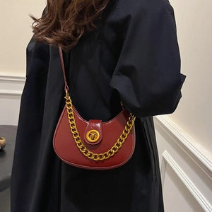 Minimalist wine red crescent shoulder bag with golden chain and metallic twist lock