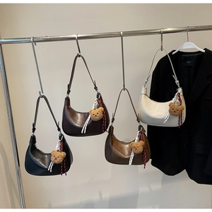 Detail of hobo moon bags in four colors with cute teddy bear charms and shoulder straps