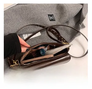 Internal storage view of the vintage brown crossbody bag showing spacious capacity