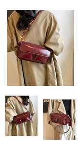 Macro view of vintage burgundy wrinkled leather cross-body bag with Paris embossed logo