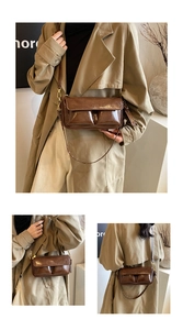 Detail view of dark brown leather crossbody bag with PARIS embossing and front pockets