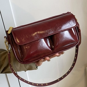 Glossy burgundy leather baguette shoulder bag with PARIS embossing and gold rivet strap
