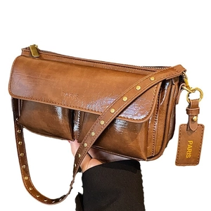 Vintage brown oil wax leather shoulder bag with a rectangular pocket design and gold zippers