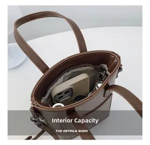 Top view of compact brown crossbody bucket bag interior with zipper pocket and phone