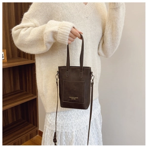 Close-up of retro brown PU leather mini bag featuring an external card slot and shoulder strap