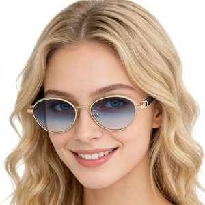 Fashionable oval gold metal sunglasses with blue gradient lenses on female model