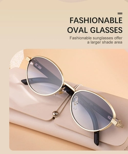 Detail of oval metal sunglasses with gradient lenses resting on a leather case