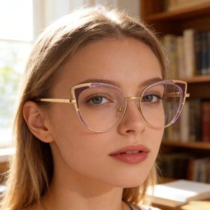 Close-up of cat-eye frames featuring gold metal and purple translucent accents