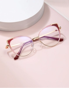Detailed view of cat-eye frames with gold metal temples and pink trim, model 82166 C5