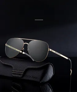 Detail of men's pilot sunglasses with gold stainless steel frame and dark polarized lenses