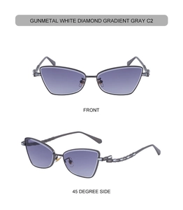 Detail of gunmetal cat eye sunglasses with rhinestone temple accents and gradient gray lenses