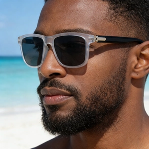 Detail of square polarized sunglasses with matte frames and metal hinge arrow on model