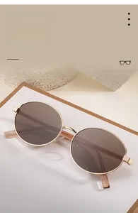 Detailed close-up of polarized oval sunglasses with gold frame and silicone nose pads