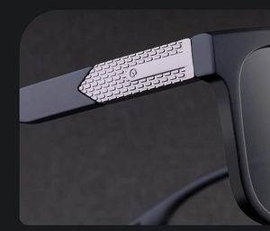 Macro view of matte black sunglasses frame with detailed silver metal hinge engraving
