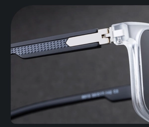 Macro detail of metal spring hinge and non-slip texture on square frame sunglasses