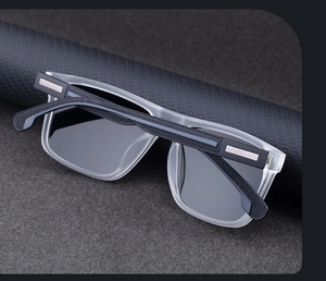 Detail of square polarized sunglasses featuring grey frames and textured non-slip temples
