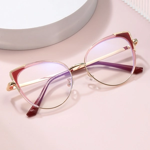 Chic cat-eye anti-blue light glasses with gold and wine red metal frames on pink display