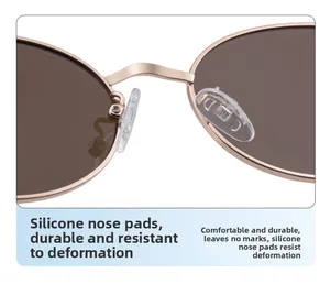Détail de la monture en métal or rose avec verres bruns et plaquettes en silicone